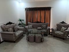 7 seater sofa with a centre table and 4 additional stools