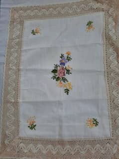 an hand  embroidered bed sheet with two pilows