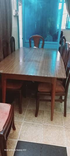 Wooden dining table with self's