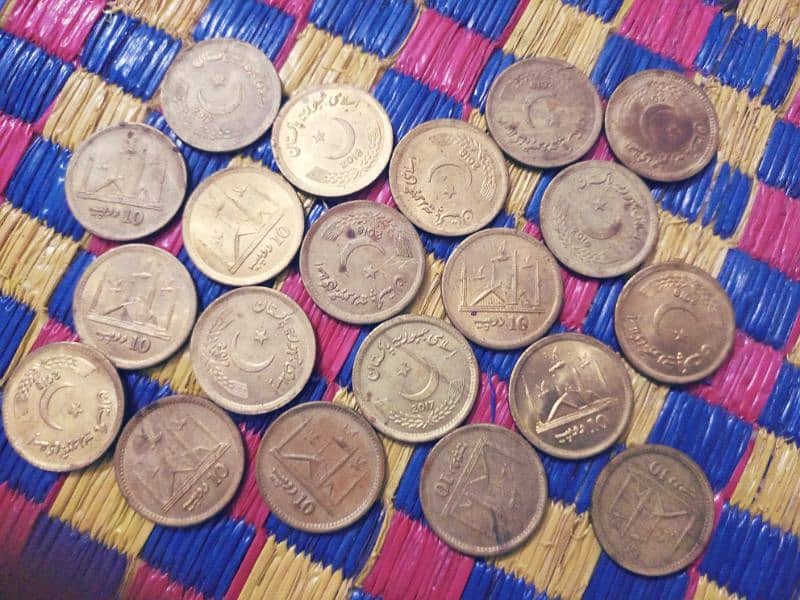 10 rupees coin and 5 penny of us 0