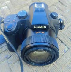 Lumix FZ 1000 DSLR camera with original box charger strap battery lens