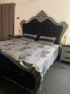 king size bed with side table and dresser