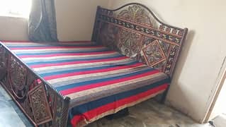 iron double bed selling with a mattress.