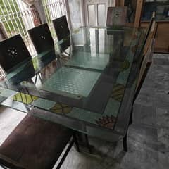 Glass dining table with 8 chairs. Slightly defected