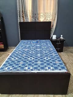 wooden single bed with mattress