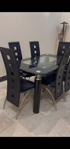 slightly used 6 chairs glass dinning table available in defence