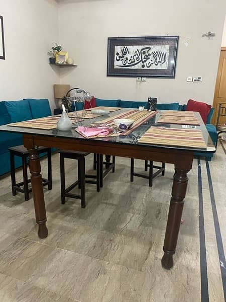 Dining table with glass top and 6 wooden chairs 1