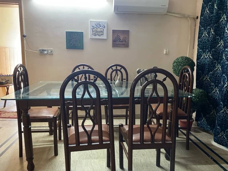 Dining table with glass top and 6 wooden chairs 2