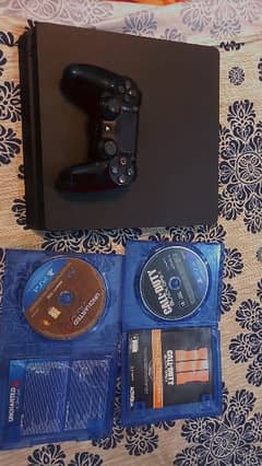 PS4 Slim 1Tb (used) , 1 controller and 2 discs