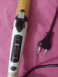 Hair straightener plus curler of kemei brand.