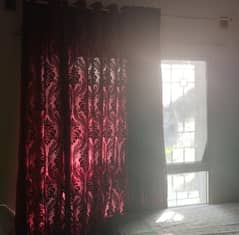 Maroon chiffon net curtains and brown floor to ceiling curtains