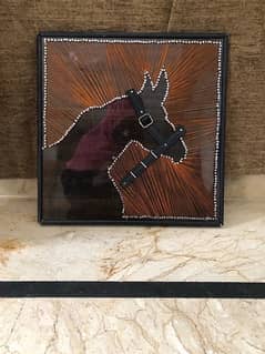 String Art of horse on wooden sheet