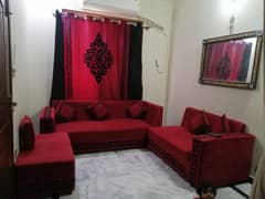 L shaped sofa with velvet curtain