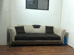 brown and beige wooden sofa set with 5 cushions