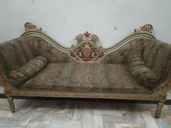 made of wood sofa and with two pilo