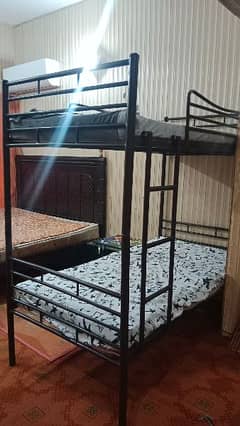 bunk bed in a very neat condition with wooden sheet. . . . .