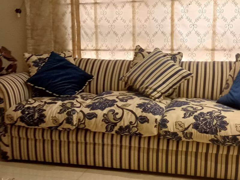 Beautiful Sofa in blue stripes and floral cushions 1