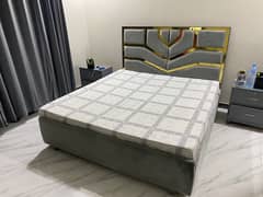 bed and mattress with side tables and dressing table