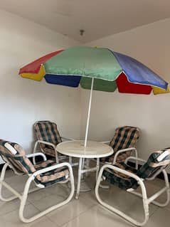 Garden chairs , table and umbrella fairy used for sale