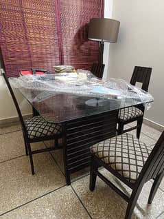 dinning table and 6 chairs with glass top