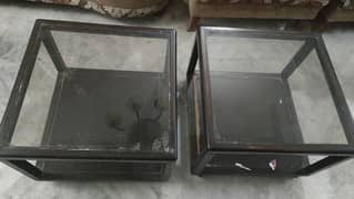 2 glass top tables with wheels