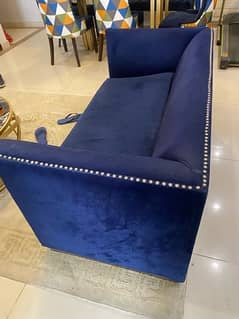 2 seater Sofa with velvet finish and golden bottom design