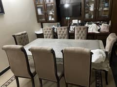 Dining table glass top wooden solid base . 8 chairs ,very good condit