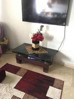 wooden center table with glass top