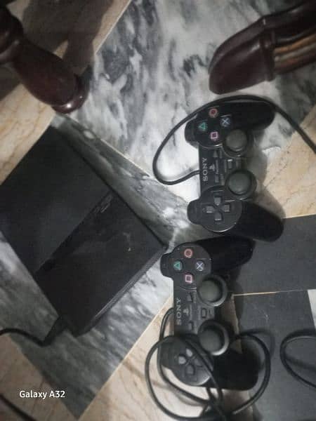 ps2 slim version with 10 games and  2 controllers 10/10 working fifa 0