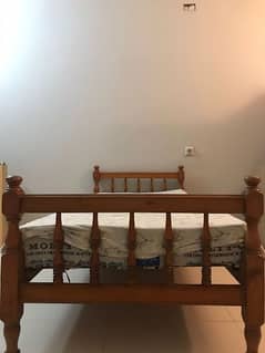 wooden bed with mattress