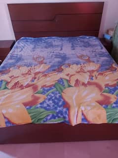 A wooden king size double bed with 9 inch spring matras