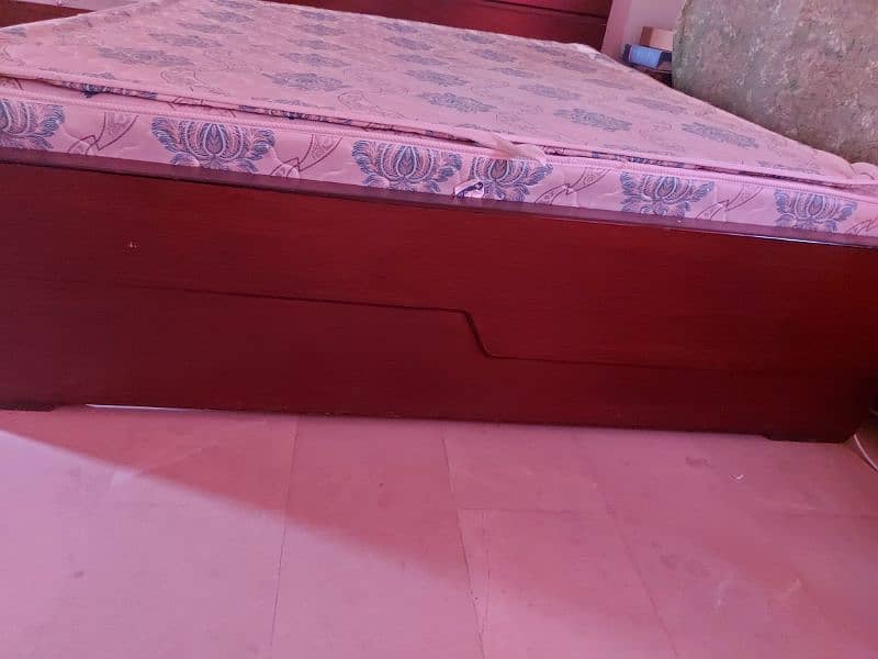 A wooden king size double bed with 9 inch spring matras 1