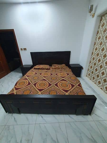 Full size bed with side tables. 1