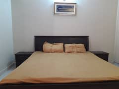 wooden bed with mattress and side table 0