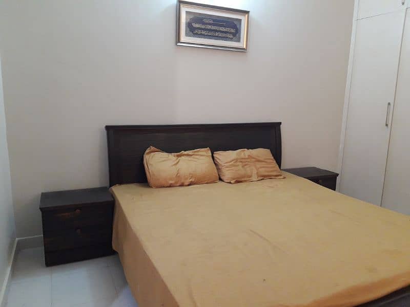 wooden bed with mattress and side table 1