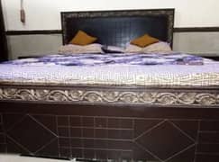 wooden king size bed with side tables