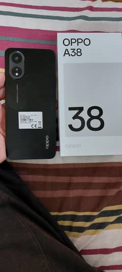 Oppo A38. . . Features: 6/128 , Battery: 5000 mAh,  Main camera: 50MP