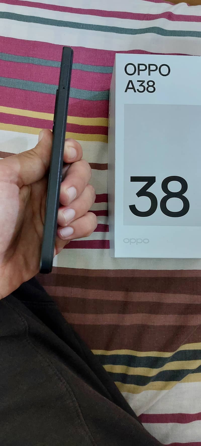 Oppo A38. . . Features: 6/128 , Battery: 5000 mAh,  Main camera: 50MP 1