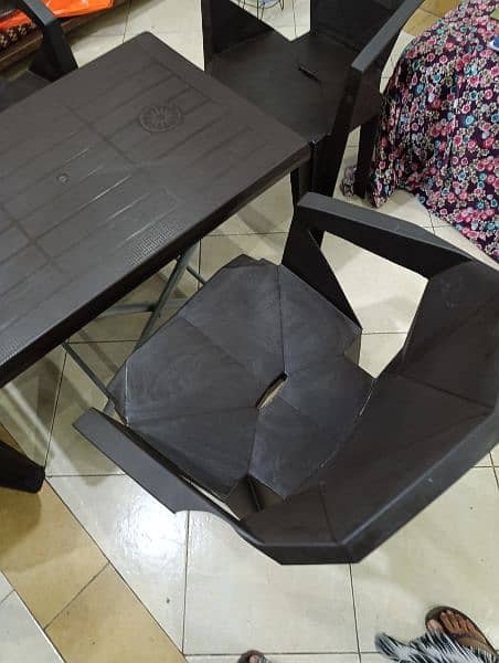 Brown Plastic Table with 4 Chairs 1