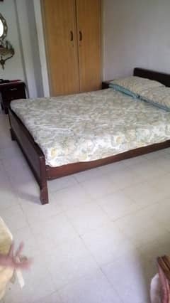 Wooden double bed with mattress and two side tables