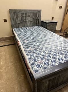 single bed with foam and one side table