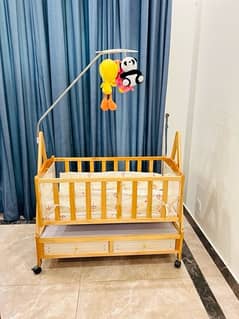 wooden baby cot and swing.