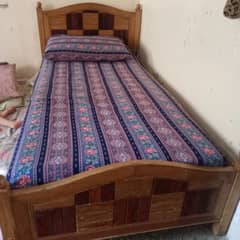 2 wooden single beds