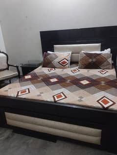 king size bed with chairs and table