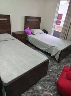 single bed pair with 1 side table