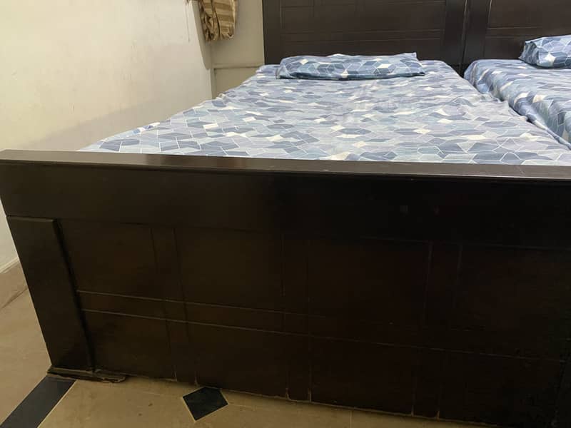 Gently used wooden 2 single bed 0