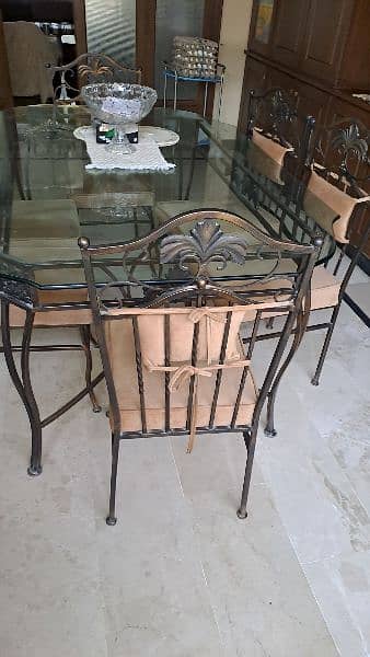 Almost new wrought iron dining table with 6 chairs 4