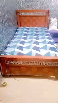 Wooden bed with mattress