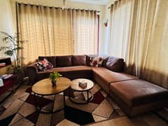 L shaped sofa with one big centre table and imported rug