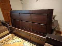 slightly used wooden bed with side tables